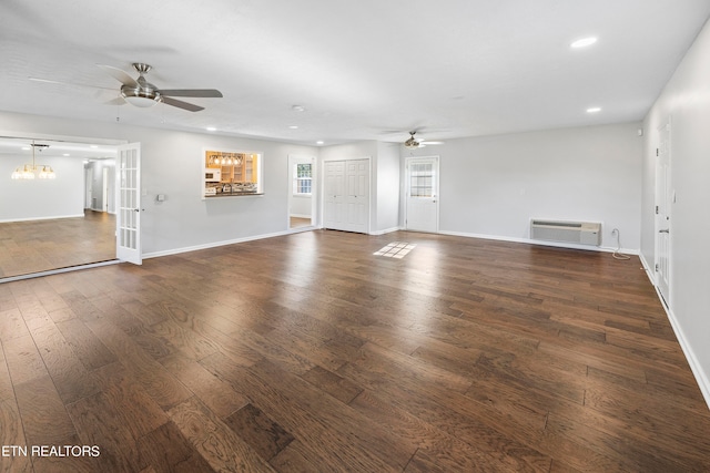 unfurnished living room with recessed lighting, an AC wall unit, wood-type flooring, and ceiling fan with notable chandelier