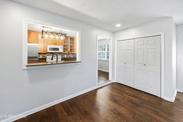 interior space featuring dark wood-style floors, recessed lighting, and baseboards