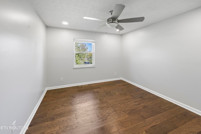 empty room featuring a textured ceiling, dark hardwood / wood-style floors, and ceiling fan