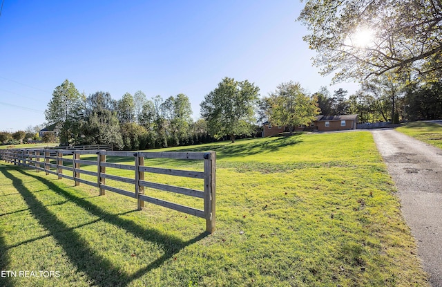 exterior space with fence and a yard