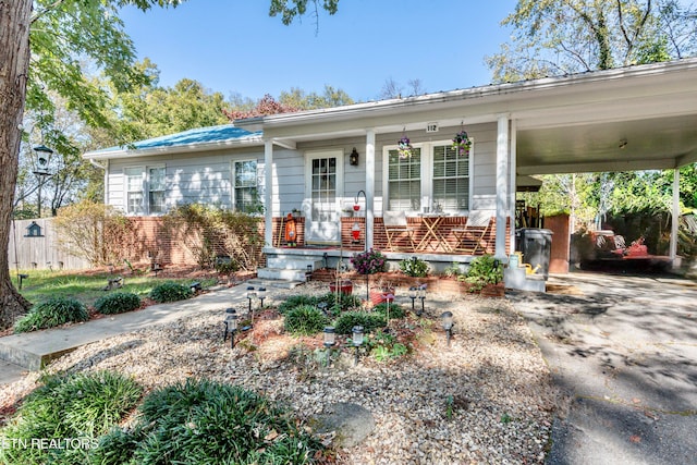 ranch-style home with a carport and a porch