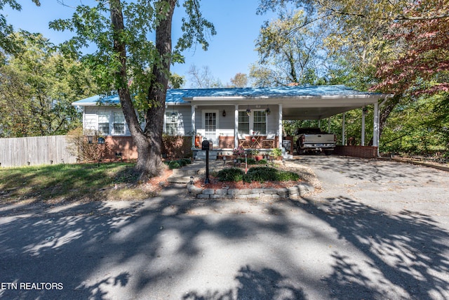 exterior space featuring covered porch and a carport