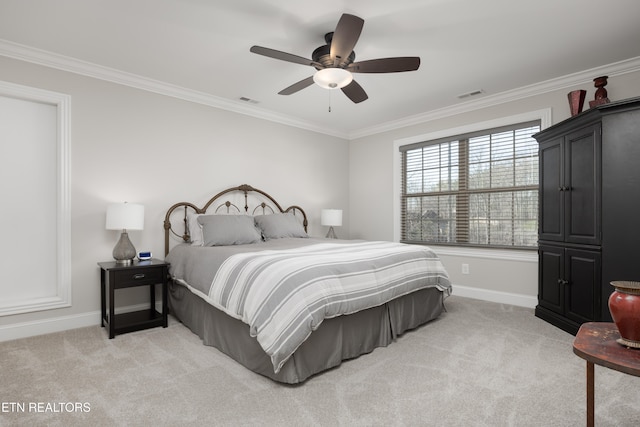 carpeted bedroom with ornamental molding and ceiling fan