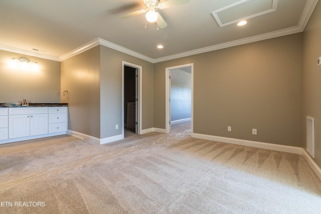 unfurnished bedroom featuring a spacious closet, ornamental molding, light colored carpet, and ceiling fan