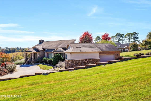 ranch-style house with a garage and a front lawn