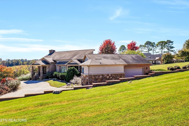 3909 Logans Landing Cir, Louisville, TN 37777 - view of front of home with a front yard, stone siding, an attached garage, and a chimney