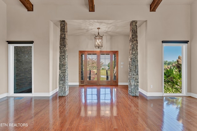 3909 Logans Landing Cir, Louisville, TN 37777 - interior space with beamed ceiling, an inviting chandelier, wood finished floors, and baseboards