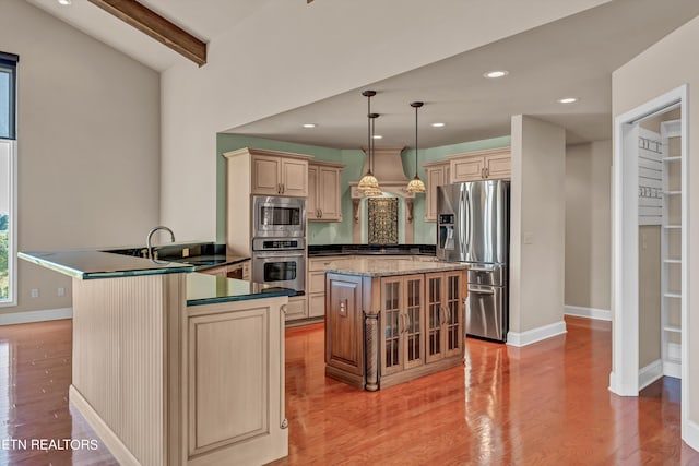 3909 Logans Landing Cir, Louisville, TN 37777 - kitchen with appliances with stainless steel finishes, light wood-type flooring, baseboards, a center island, and a peninsula