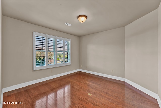 empty room featuring wood-type flooring