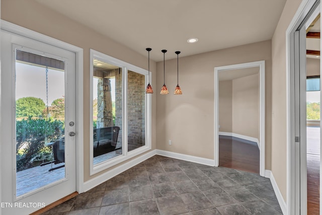 unfurnished dining area featuring dark wood-type flooring