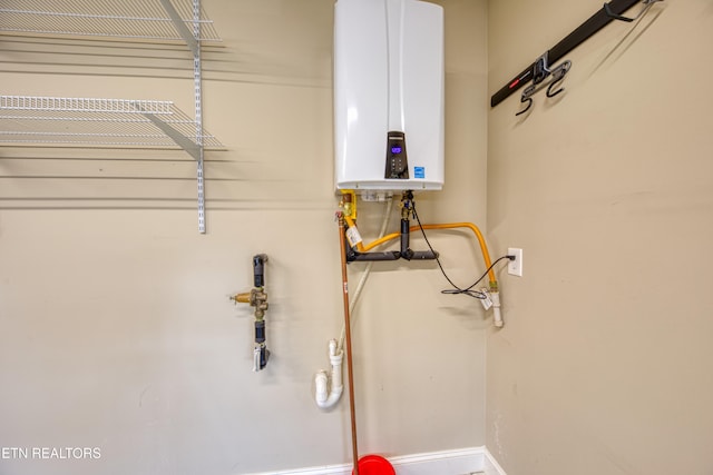 clothes washing area with water heater