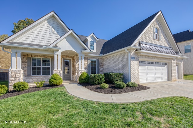 craftsman-style house featuring a front yard, a garage, and a porch