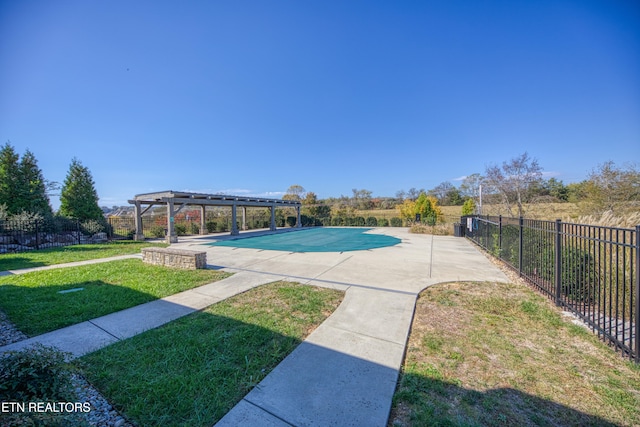 view of pool with a patio area, a lawn, and a pergola