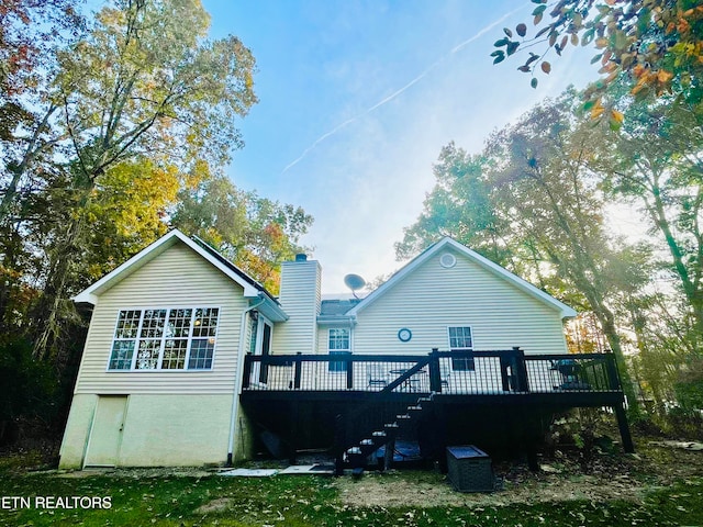 back of house featuring a wooden deck