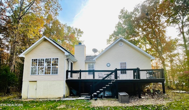 rear view of house featuring a wooden deck