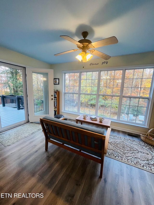 interior space featuring ceiling fan, dark wood-type flooring, and plenty of natural light