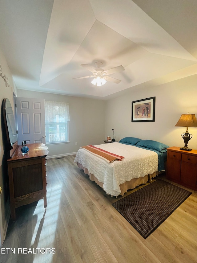 bedroom with ceiling fan and light hardwood / wood-style flooring