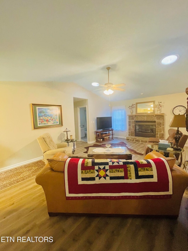 living room featuring ceiling fan and a fireplace