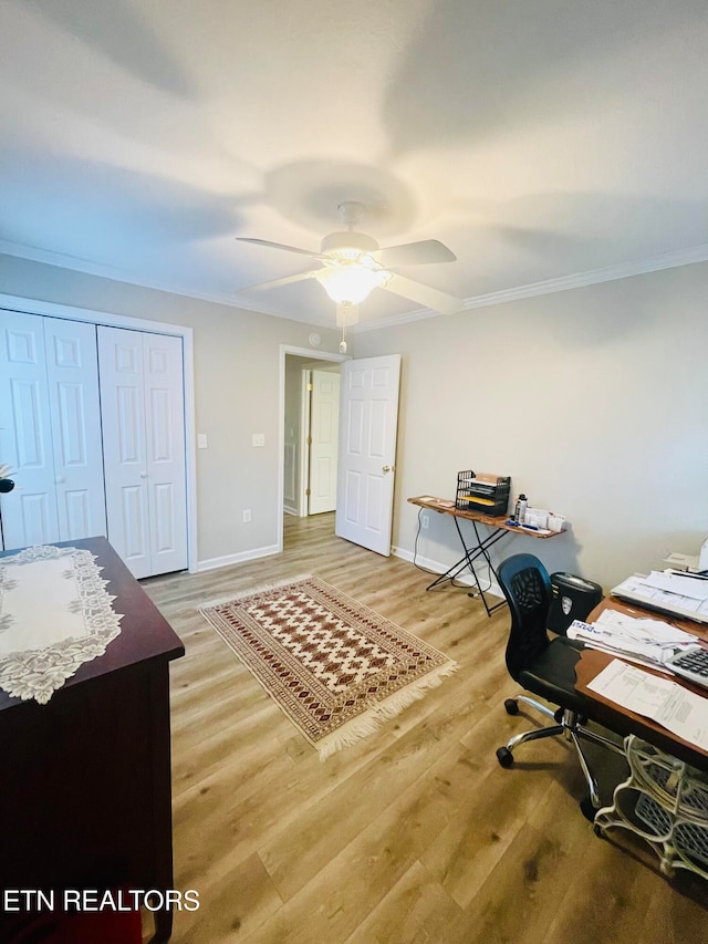 office space featuring ceiling fan, ornamental molding, and light hardwood / wood-style flooring