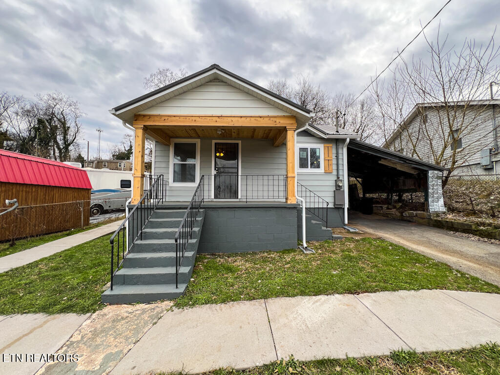 bungalow-style house with a carport and covered porch