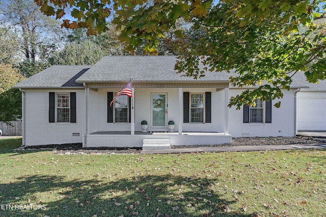 view of front of property with a front yard, covered porch, and a garage