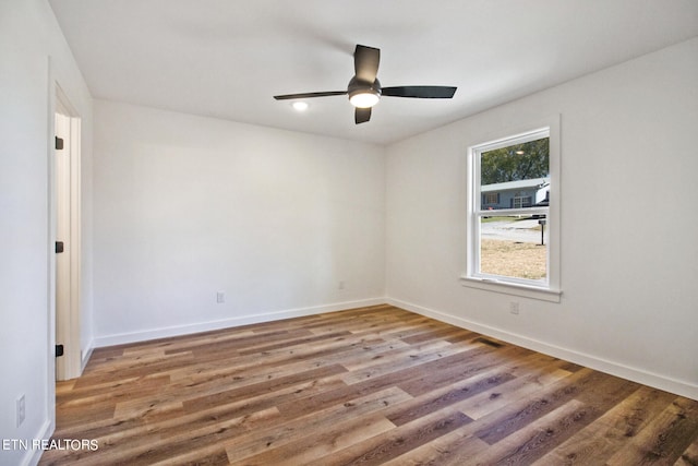 spare room with ceiling fan and hardwood / wood-style flooring