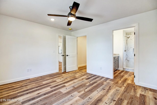 unfurnished bedroom with light hardwood / wood-style flooring, connected bathroom, and ceiling fan