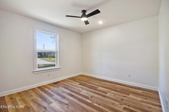 empty room featuring ceiling fan and light hardwood / wood-style flooring