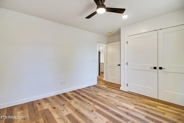 unfurnished bedroom featuring a closet, ceiling fan, and light hardwood / wood-style flooring