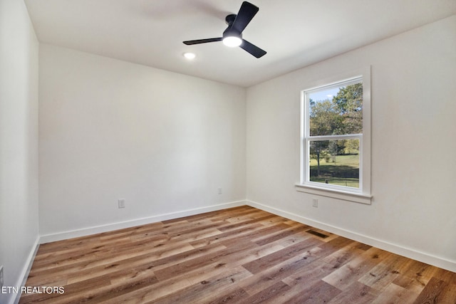 empty room with light hardwood / wood-style floors and ceiling fan