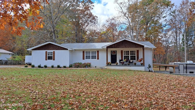 ranch-style house with a front lawn and covered porch