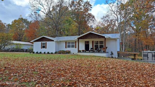 single story home featuring covered porch