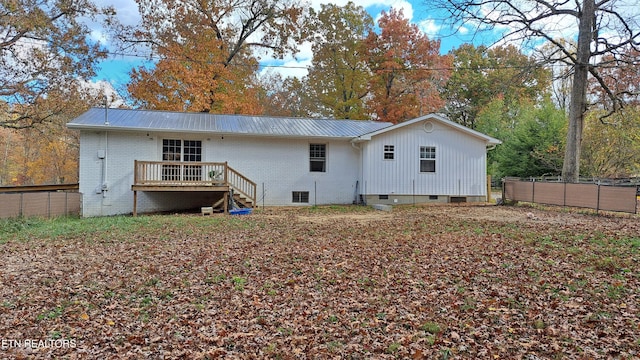 back of property featuring a wooden deck