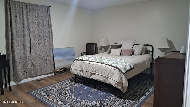 bedroom with wood-type flooring