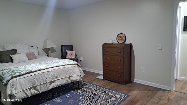 bedroom with hardwood / wood-style floors