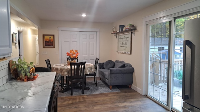 dining area with dark hardwood / wood-style floors