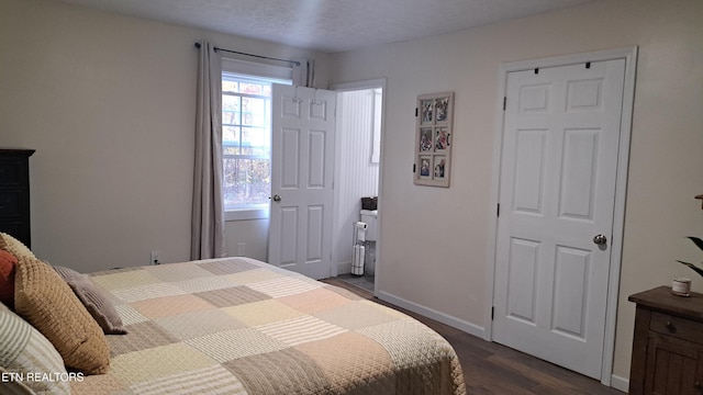 bedroom with dark wood-type flooring