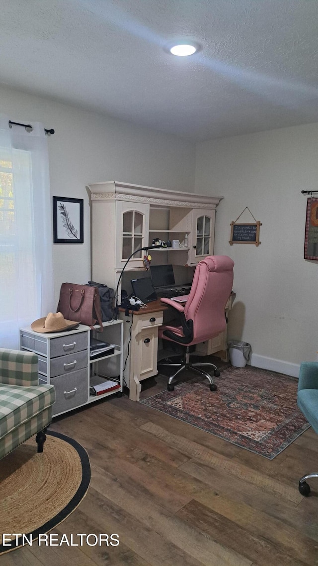 home office featuring dark hardwood / wood-style flooring and a textured ceiling