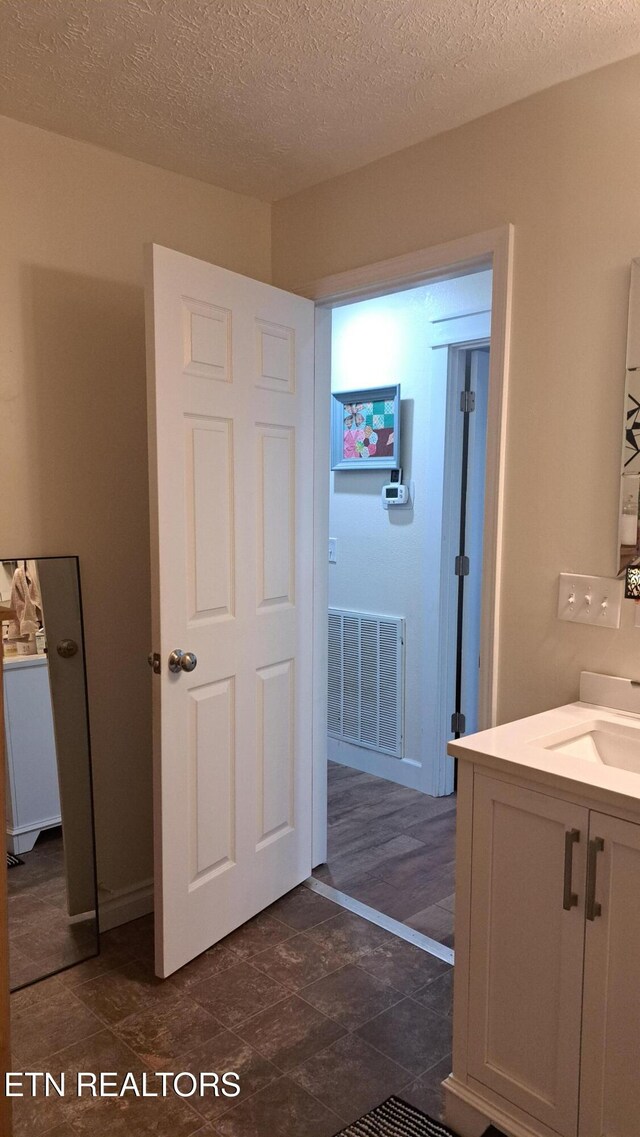 bathroom featuring vanity and a textured ceiling