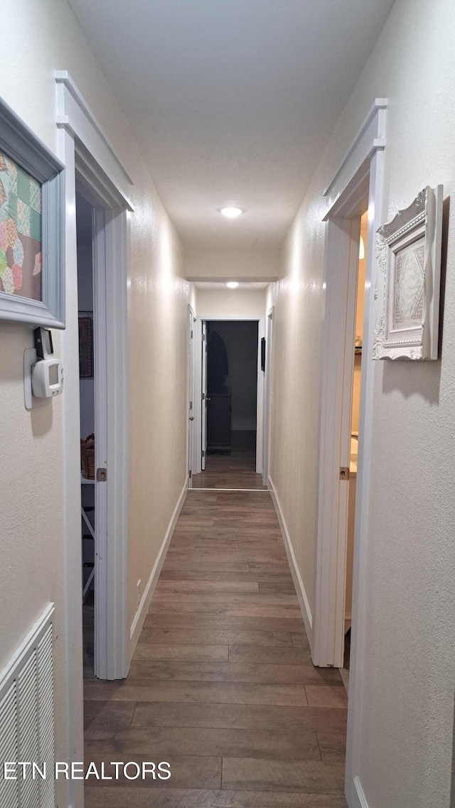 corridor with dark wood-type flooring