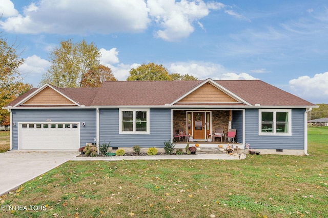 ranch-style house featuring covered porch, a garage, and a front yard