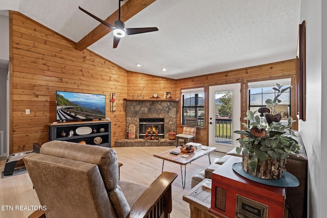 living room featuring light hardwood / wood-style floors, vaulted ceiling with beams, and wooden walls