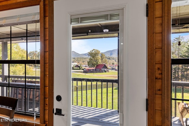 doorway with a mountain view and a healthy amount of sunlight