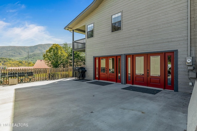 exterior space with a patio, french doors, and a mountain view