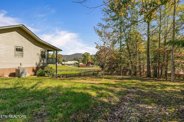 view of yard featuring a mountain view and central AC unit