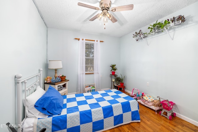 bedroom featuring a textured ceiling, hardwood / wood-style flooring, and ceiling fan