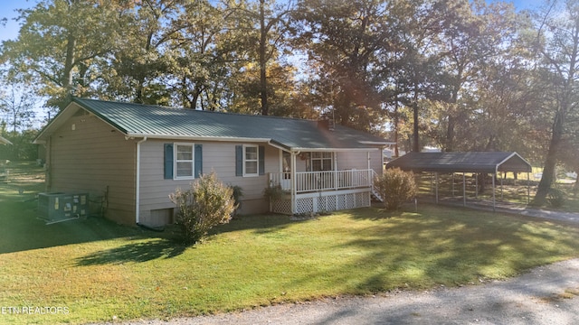 view of front of property with a porch, a front yard, and a carport