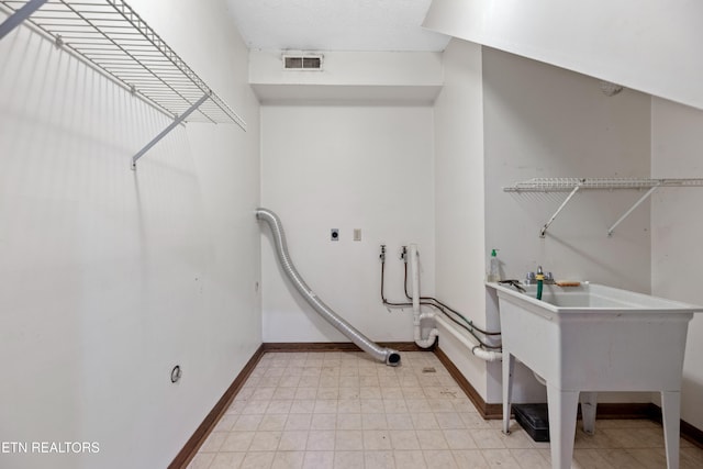 clothes washing area featuring washer hookup and hookup for an electric dryer