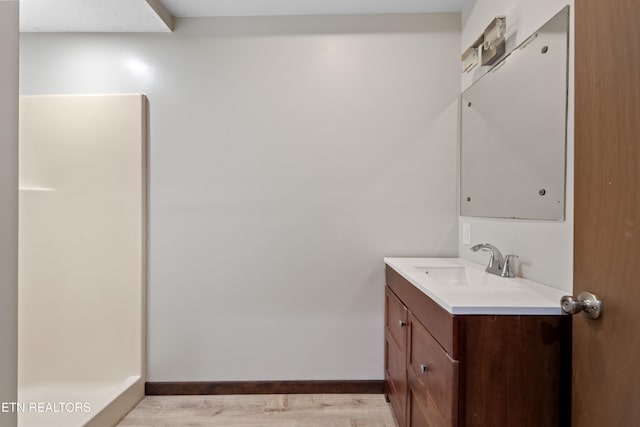 bathroom with vanity and hardwood / wood-style floors