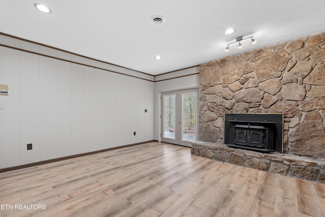 unfurnished living room with light hardwood / wood-style flooring and french doors